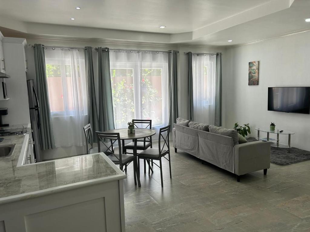 a living room with a couch and a table at Agape Suites-Room 2-Ground Floor in Soufrière