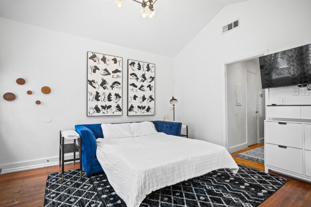 a white bedroom with a bed and a tv at Modern Midtown-The Carriage House -Free Parking in Atlanta