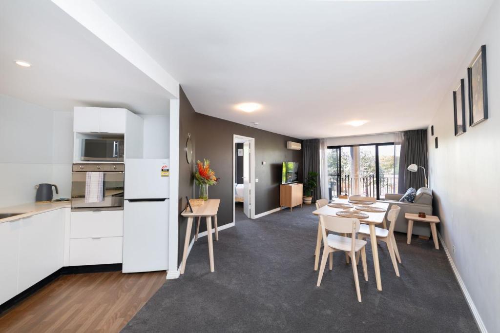a kitchen and living room with a table and chairs at Griffin 165 in Kingston 