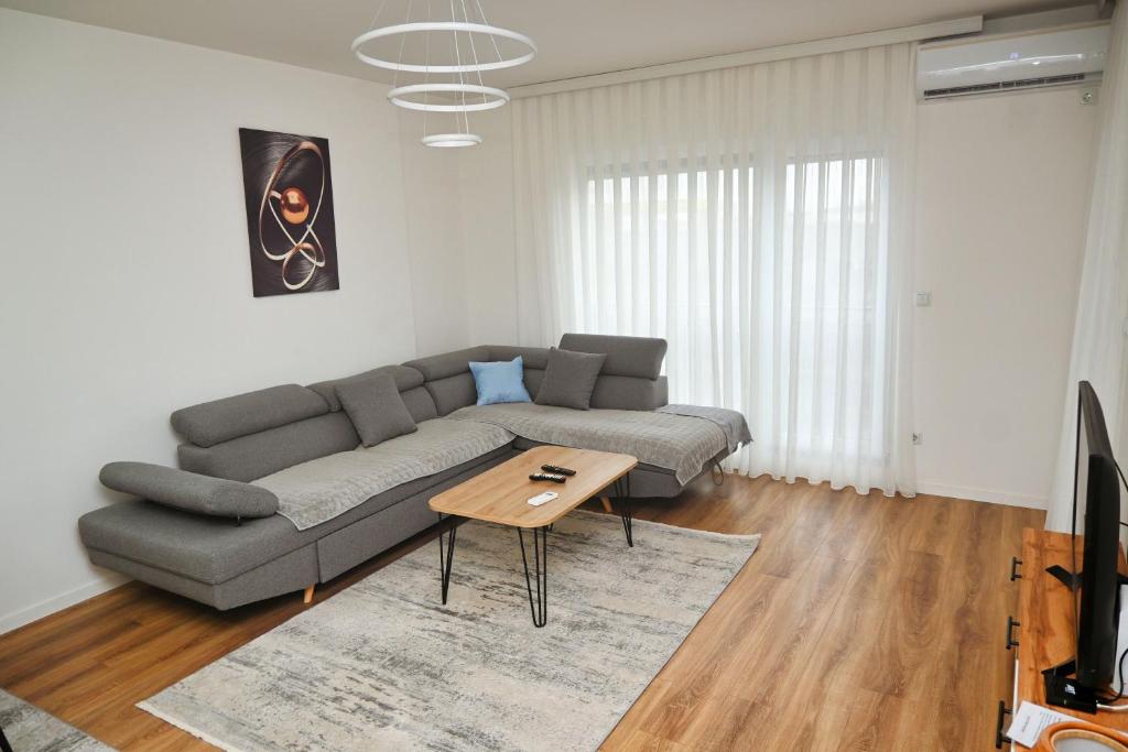 a living room with a couch and a table at Sweet Dreams Apartment in Pristina