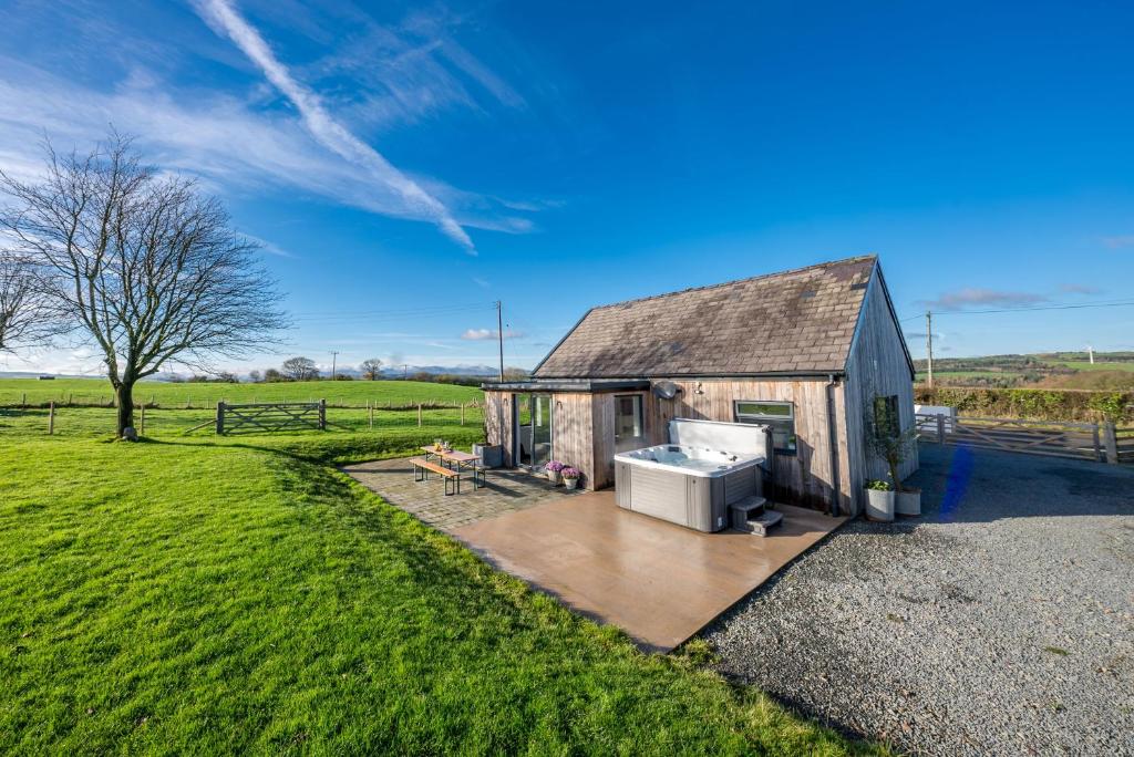 a small shed with a stove in a field at Petryal in Llangernyw