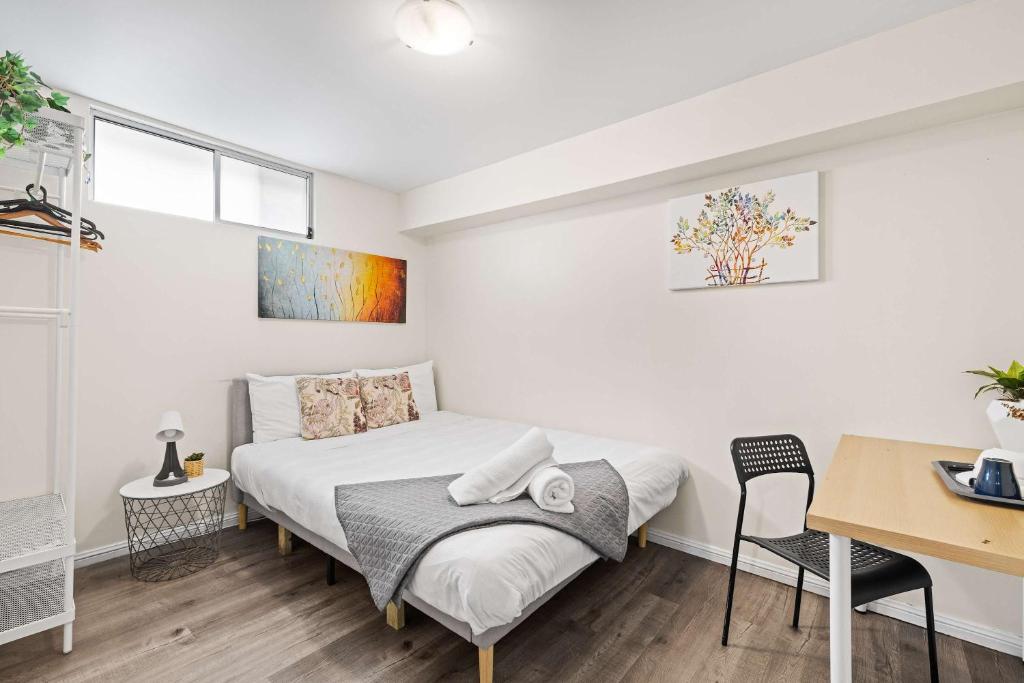 a bedroom with a bed and a table and a desk at Relaxed Private Double Room in Carramar - Close to Station - Shared Bathroom in Villawood