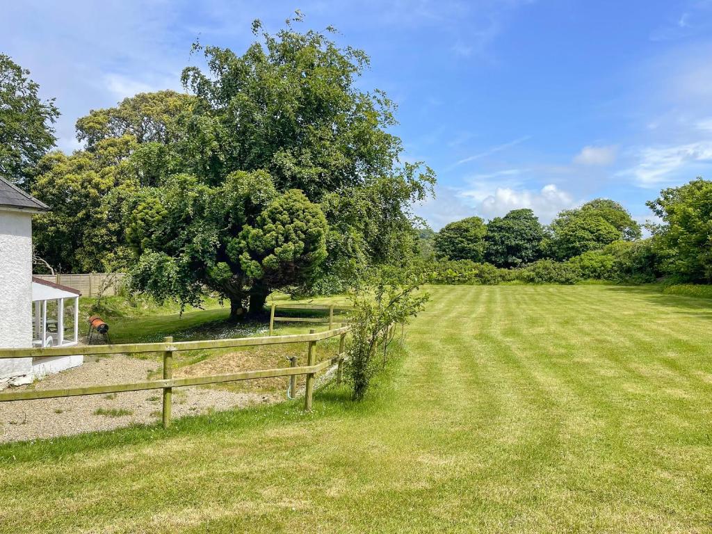 a field with a fence and a tree at Hafod Fach - Ukc6956 in Moylgrove