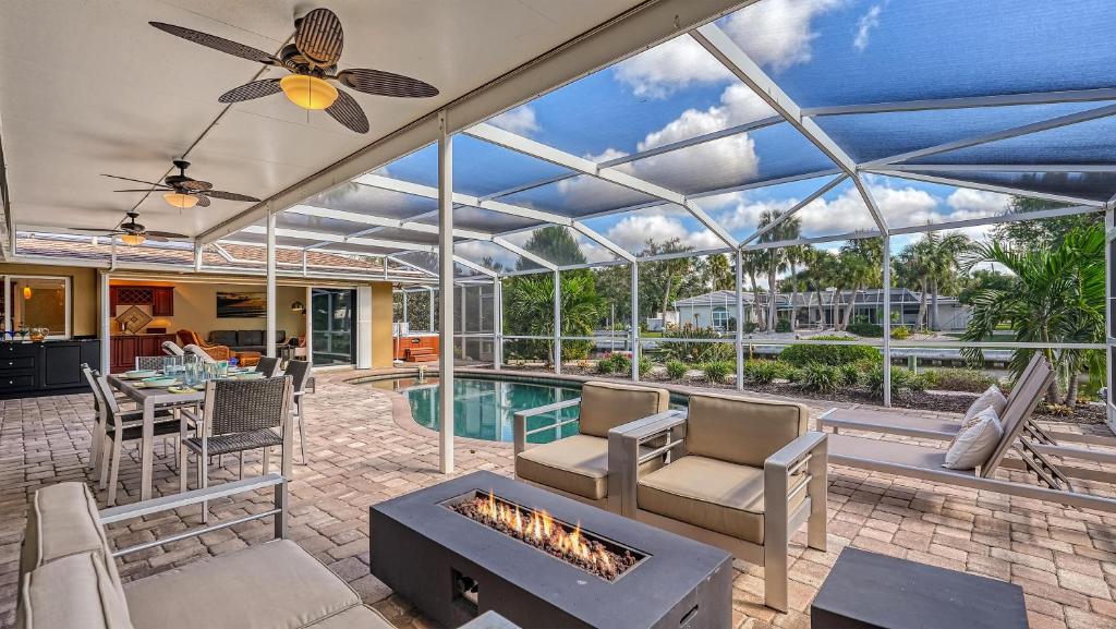 a conservatory with a pool and a living room with a fireplace at Gulf Birdie - 5551 in Siesta Key