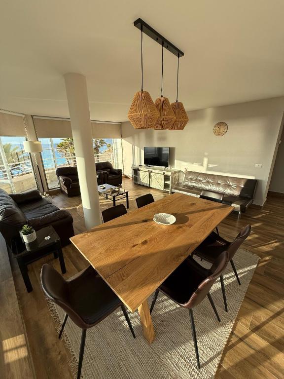 a living room with a wooden table and chairs at San Alfonso del Mar 7P in Algarrobo