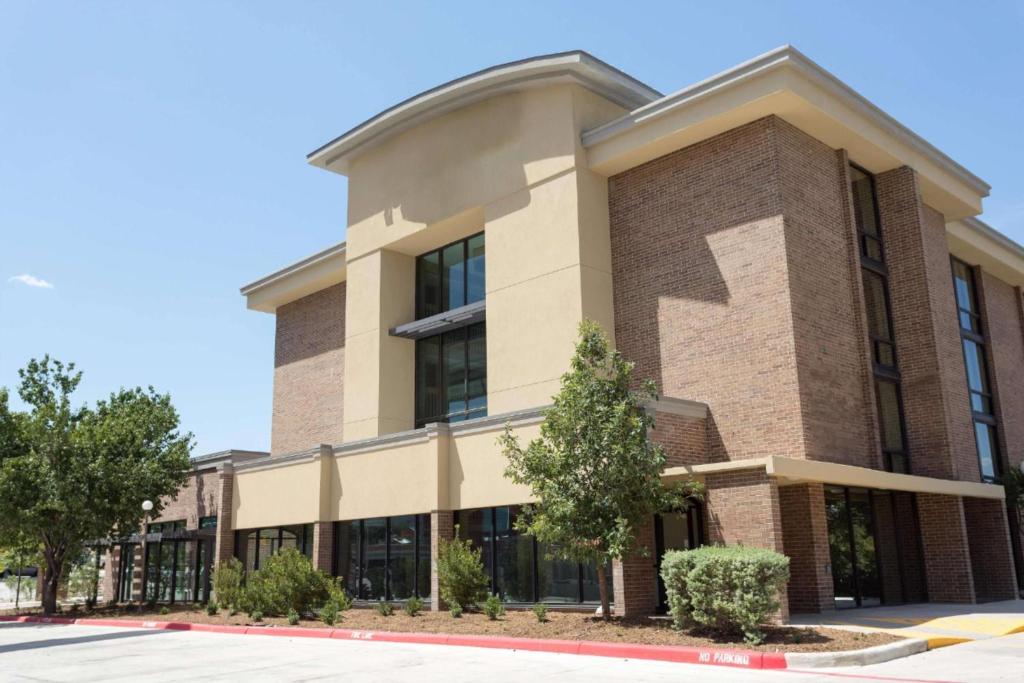 サンアントニオにあるHeritage Inn Suites San Antonio Airpt, Trademark by Wyndhamのレンガ造りの大きな建物