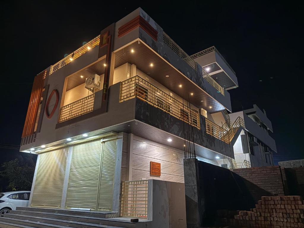 a building with lights on top of it at night at shankar guest house in Hampi