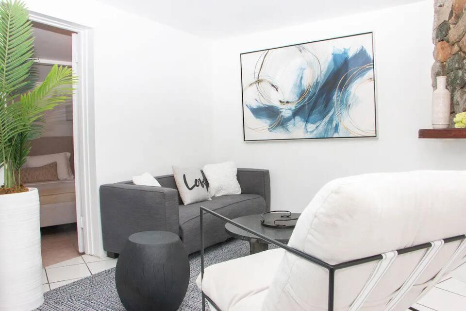 a living room with a couch and a chair at Oceanview Stay - Walk to Beach in Enighed