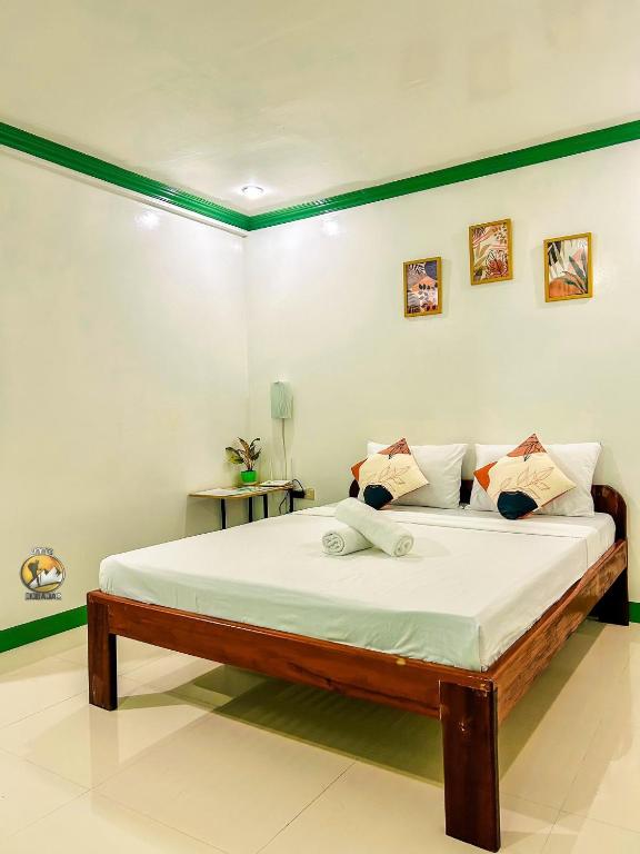 a bedroom with a large bed in a room at Felicitas Guest House- Siargao in General Luna