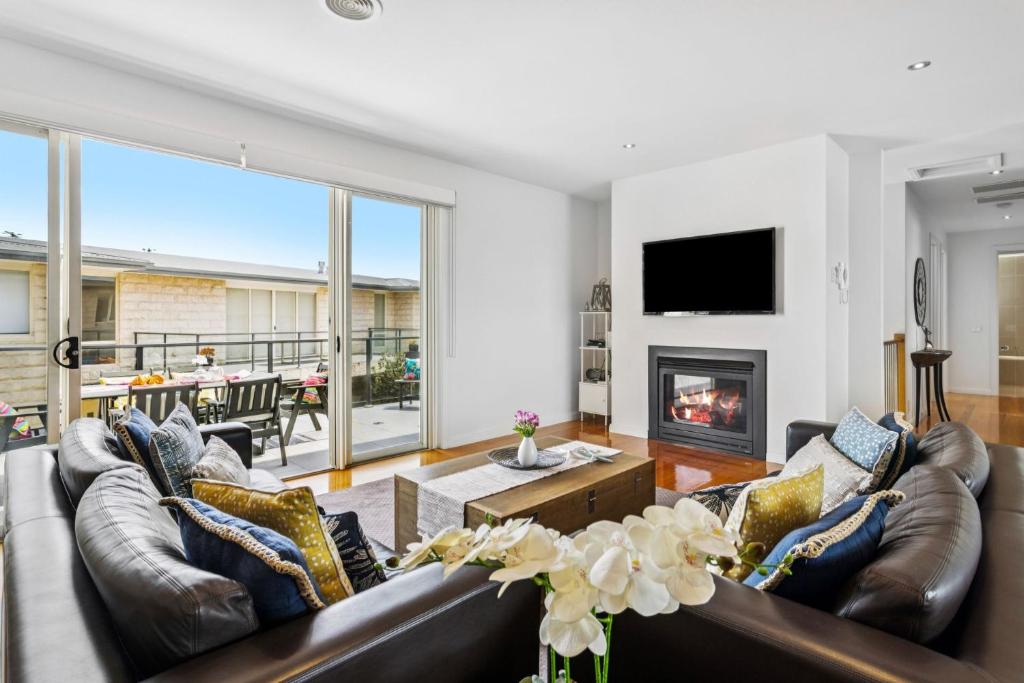 een woonkamer met een bank en een open haard bij Sorrento City Style in Sorrento