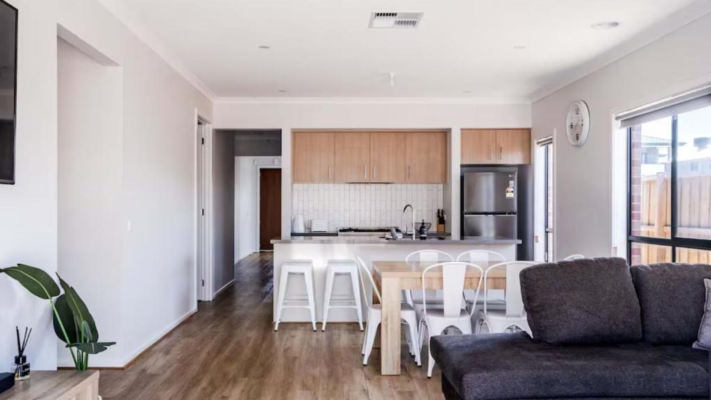 a kitchen and living room with a couch and a table at The Robinson in Connewarre