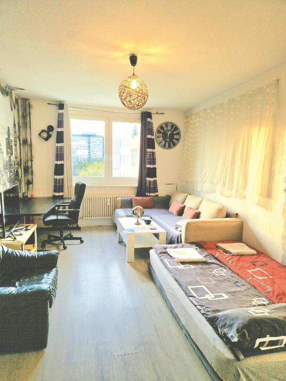 a living room with a couch and a living room at Big 24qm Room Cozy Trendy Multicultural LGTB Friendly in Shared Apartment in Green Area 12 min to Downtown Alexanderplatz in Berlin
