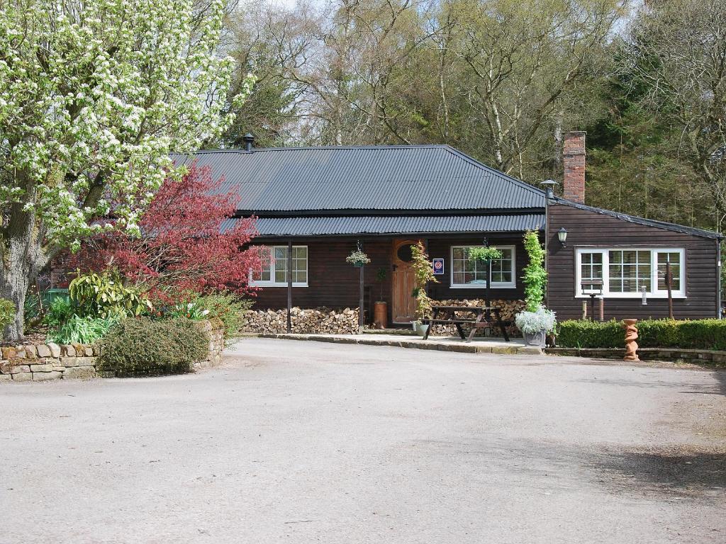 a house with a gravel driveway in front of it at High Moor Cottage in Dufton