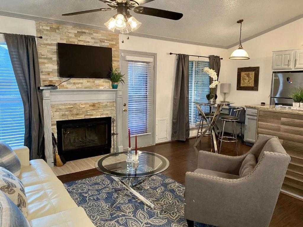 a living room with a couch and a fireplace at 1BD condo DFW South I10 in Sowers