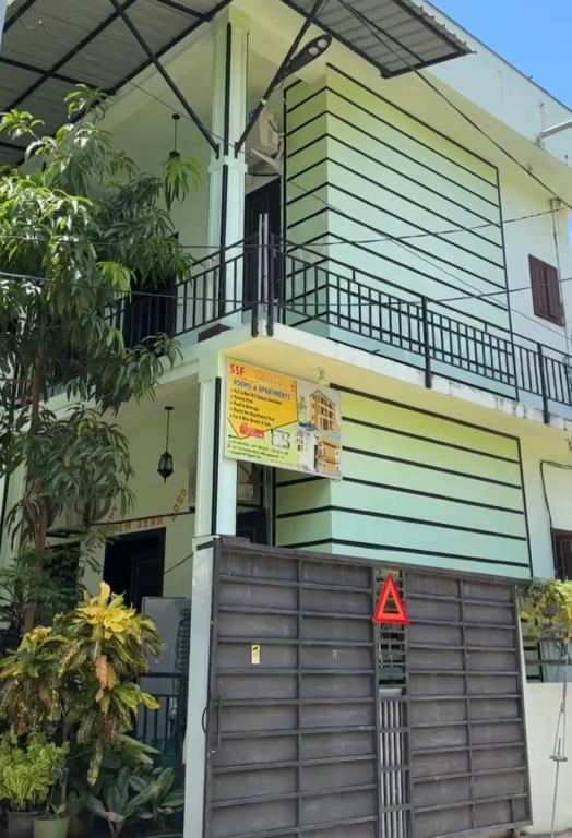 a house with a wooden gate in front of it at SSF Green Home in Akkaraipattu