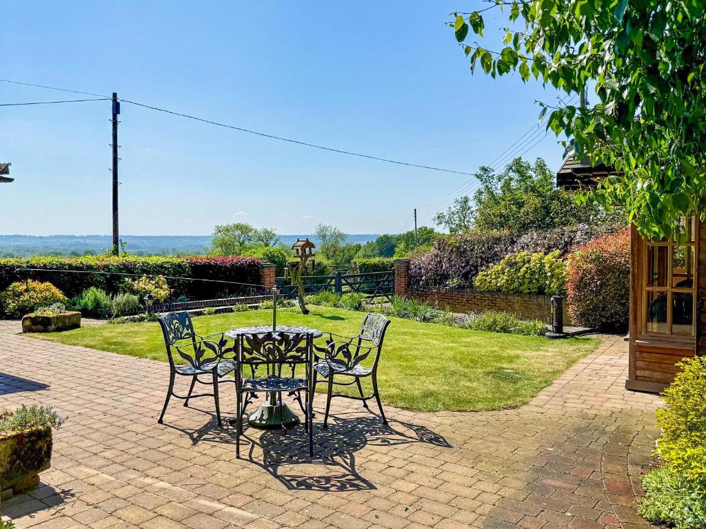 a table and chairs on a brick patio at Beech Cottage in Somersal Herbert