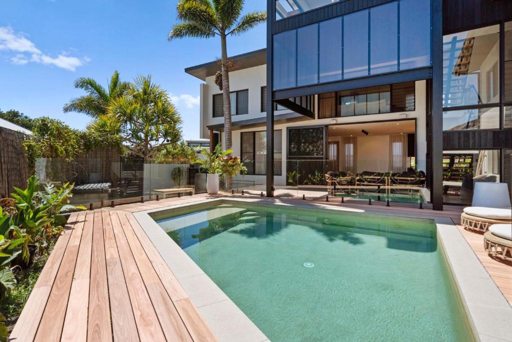 a swimming pool in the backyard of a house at Ebony Escape in Casuarina