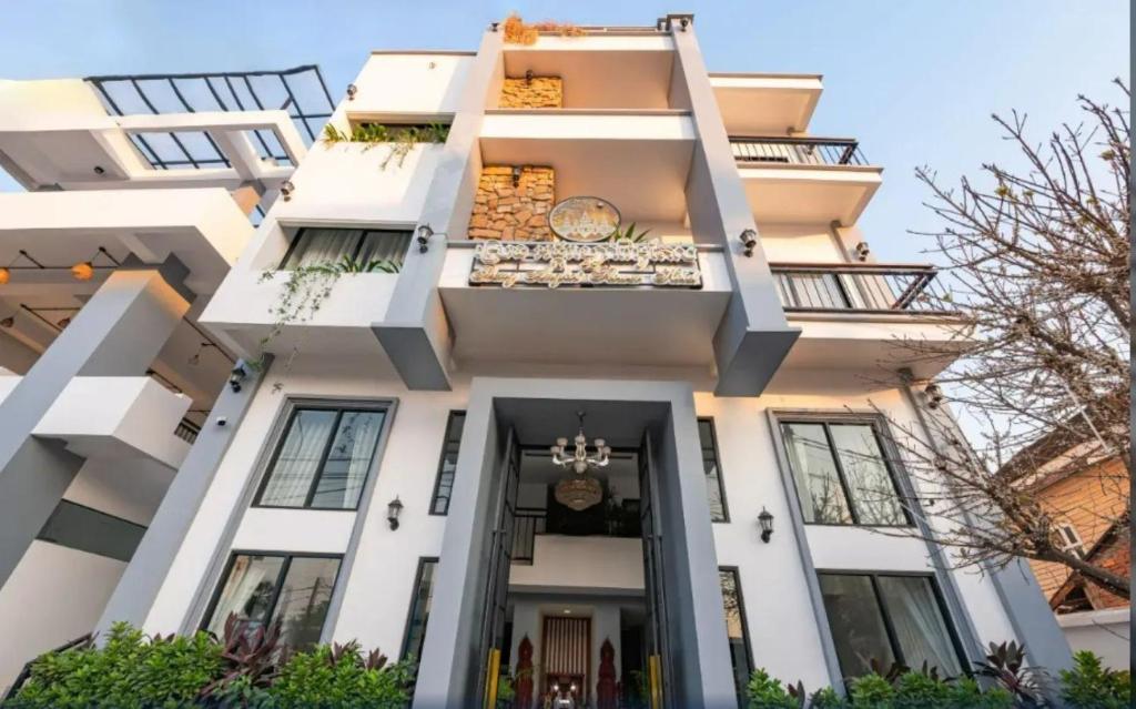 a white apartment building with a balcony at Punleu Raksmey Hotel in Siem Reap