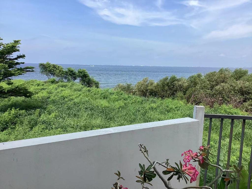 a white fence with a view of the ocean at sea l in Jakarta