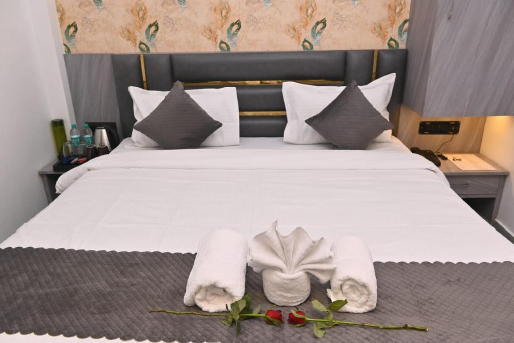 a bedroom with a bed with towels on it at Sunaina Palace in Varanasi