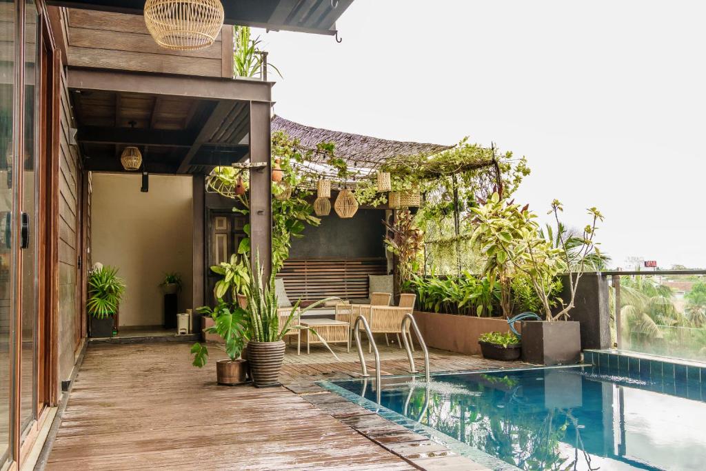 a house with a swimming pool and a patio at Penthouse by Grit Villas - Penthouse Apartment with a Private Pool in Negombo