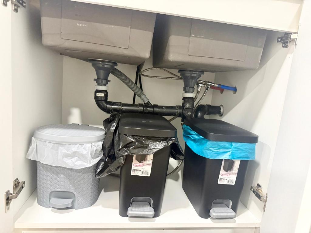 a computer monitor on a shelf with trash at Cozy 2 Bedroom Suite Close to Amenities in Edmonton