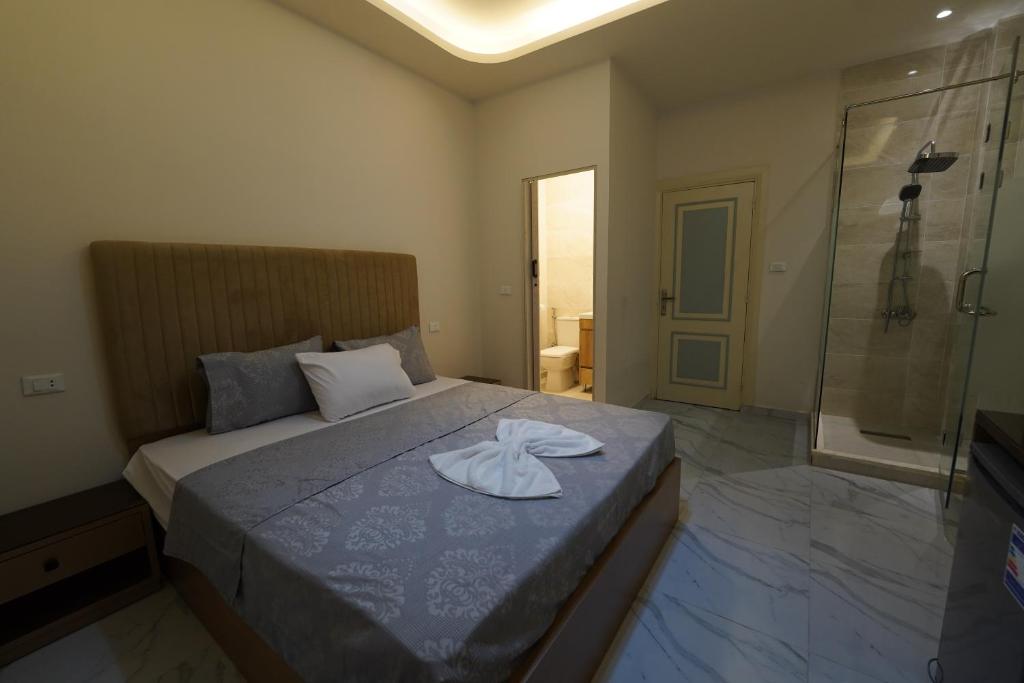a bedroom with a bed with a towel on it at maravilla downtown cairo in Cairo