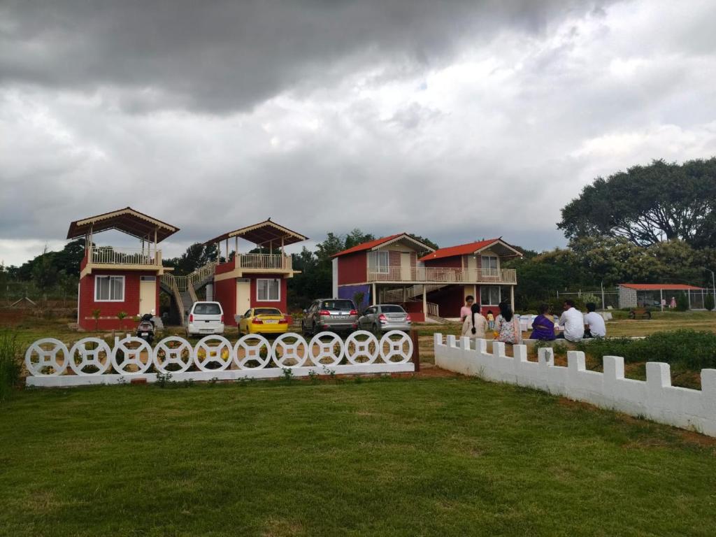 a group of houses with a fence in front of it at Anjanadri Lakeview Gardens - Sapthashree Nivasa in Hosūr