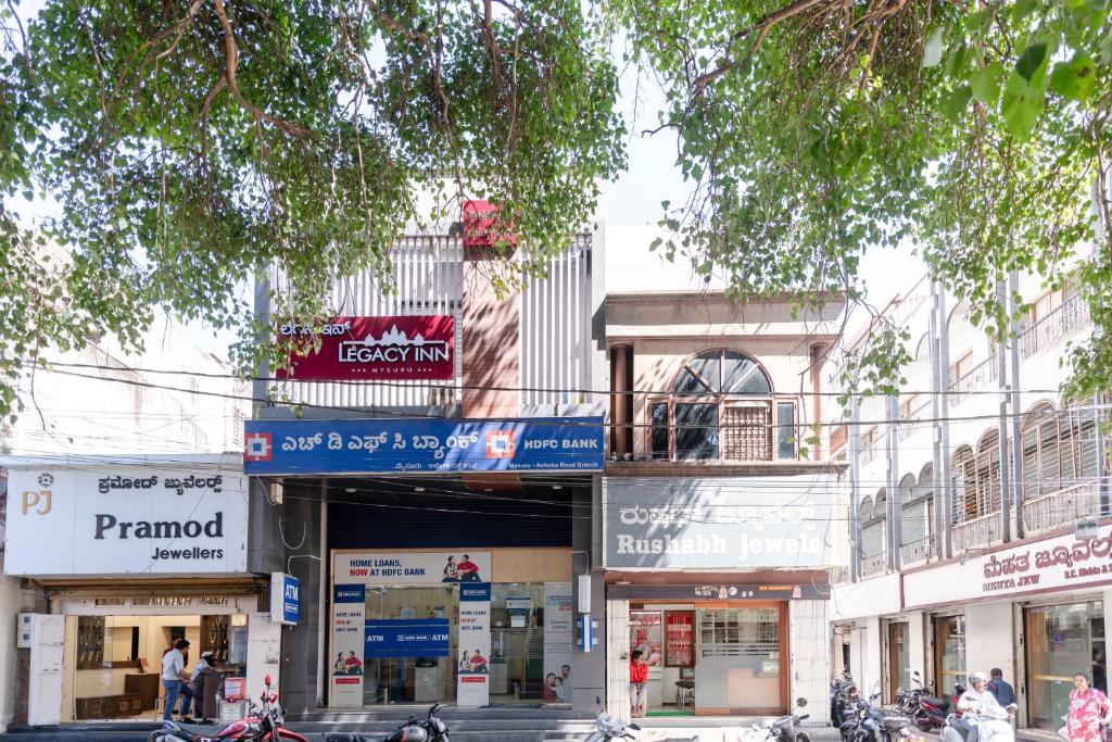 a group of shops on a city street at Legacy Inn, Mysore in Mysore