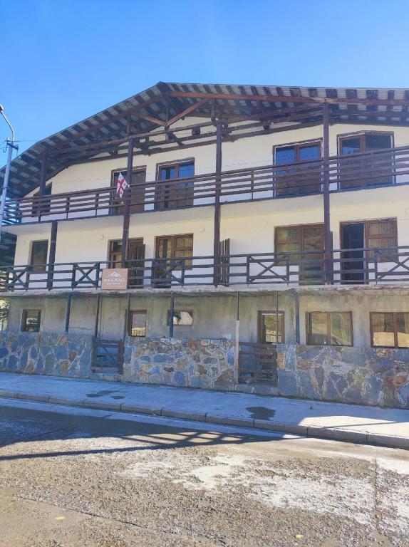 a building with balconies on the side of it at White Peaks in Mestia