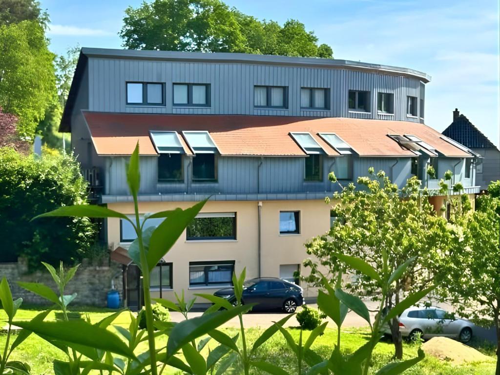 a building with solar panels on top of it at EifelZeit 1 in Kall