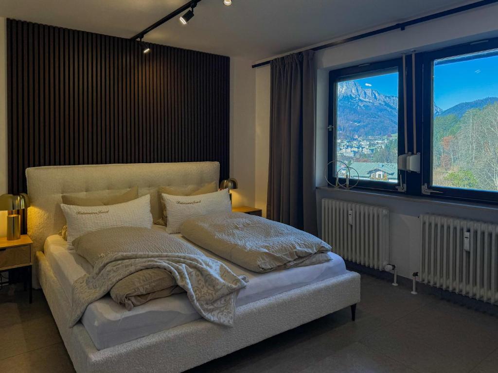a bedroom with a bed with a view of a mountain at Watzmann Juwel in Berchtesgaden
