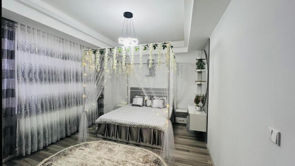 a bedroom with a canopy bed and a rug at Welcome to your home away from home! in Kabul