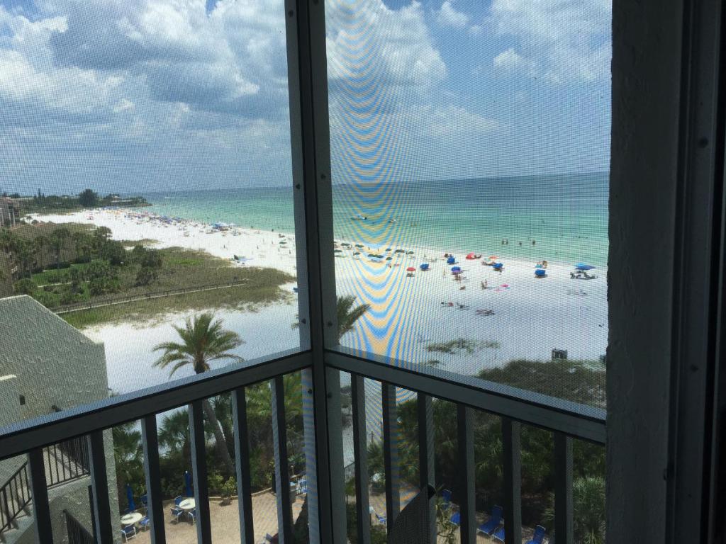 a view of a beach from a balcony at Crescent Arms Condominiums in Siesta Key