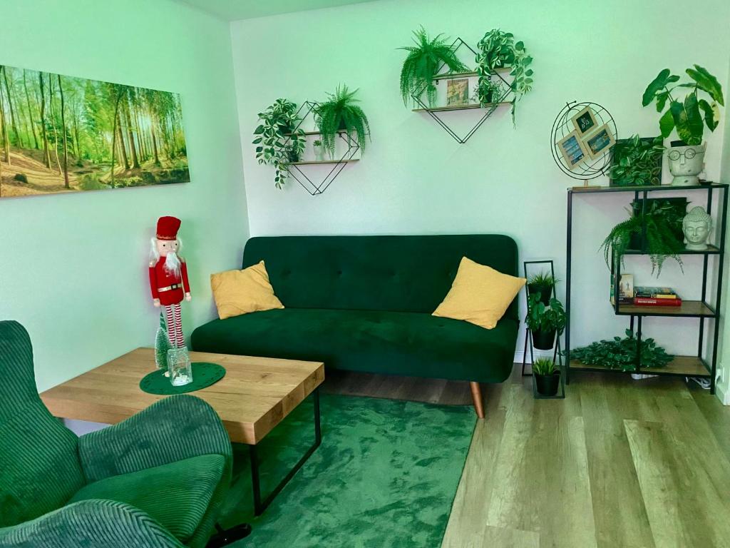a living room with a green couch and a table at Buda Side Comfort in Budapest