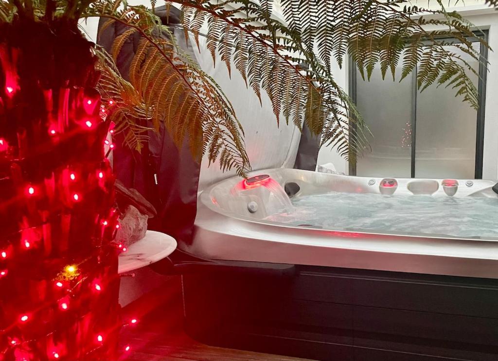 a bathroom with a bath tub with a christmas tree at cocoon romantique avec jacuzzi proche plage in Saint-Gildas-de-Rhuys
