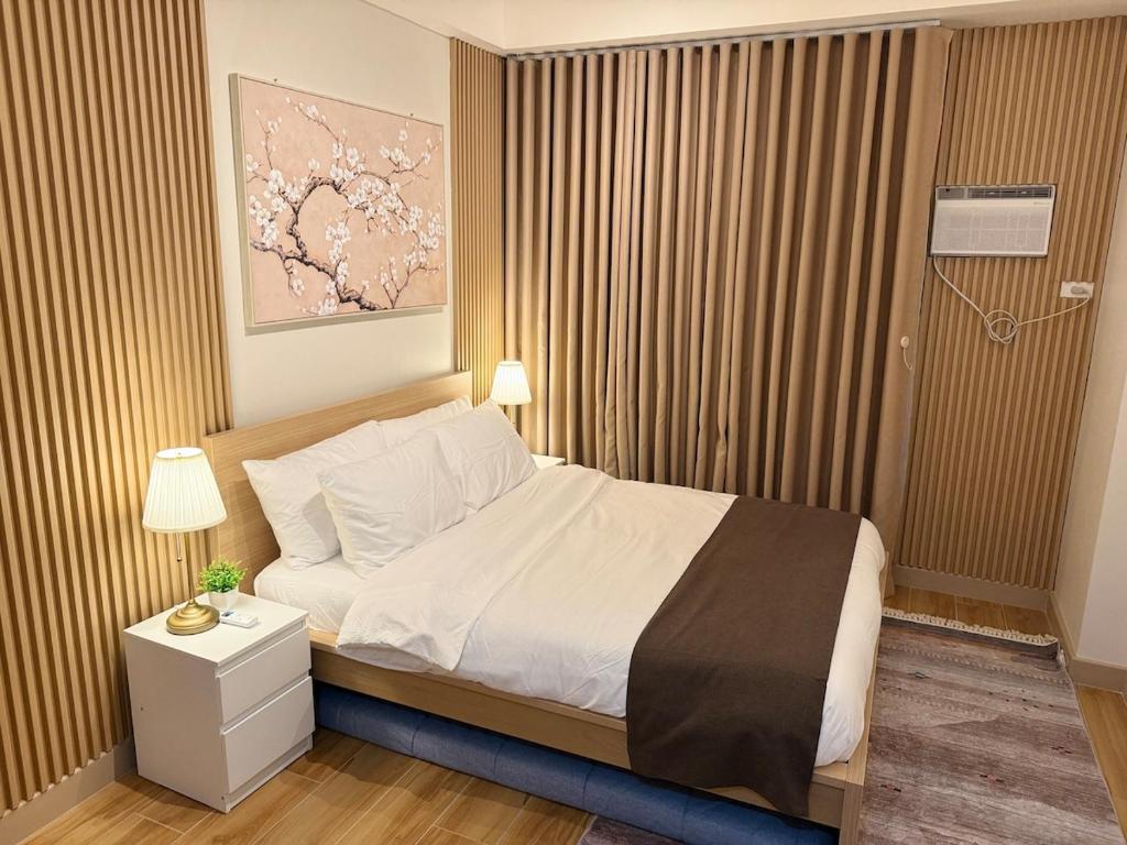 a bedroom with a large bed with a nightstand and a bed sidx sidx sidx at The Banyan Rest in Balibaguhan