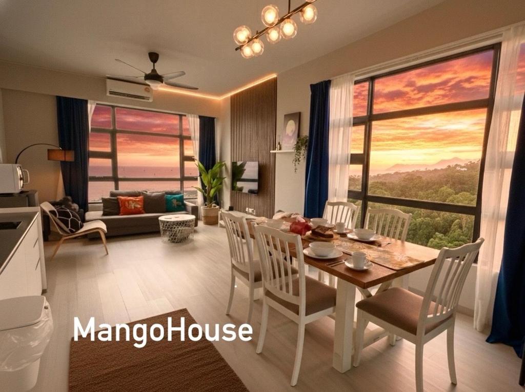 a kitchen and living room with a table and chairs at Ocean x Mount Kinabalu View- High Floor Corner Luxury Stay - Mango House5 in Kota Kinabalu