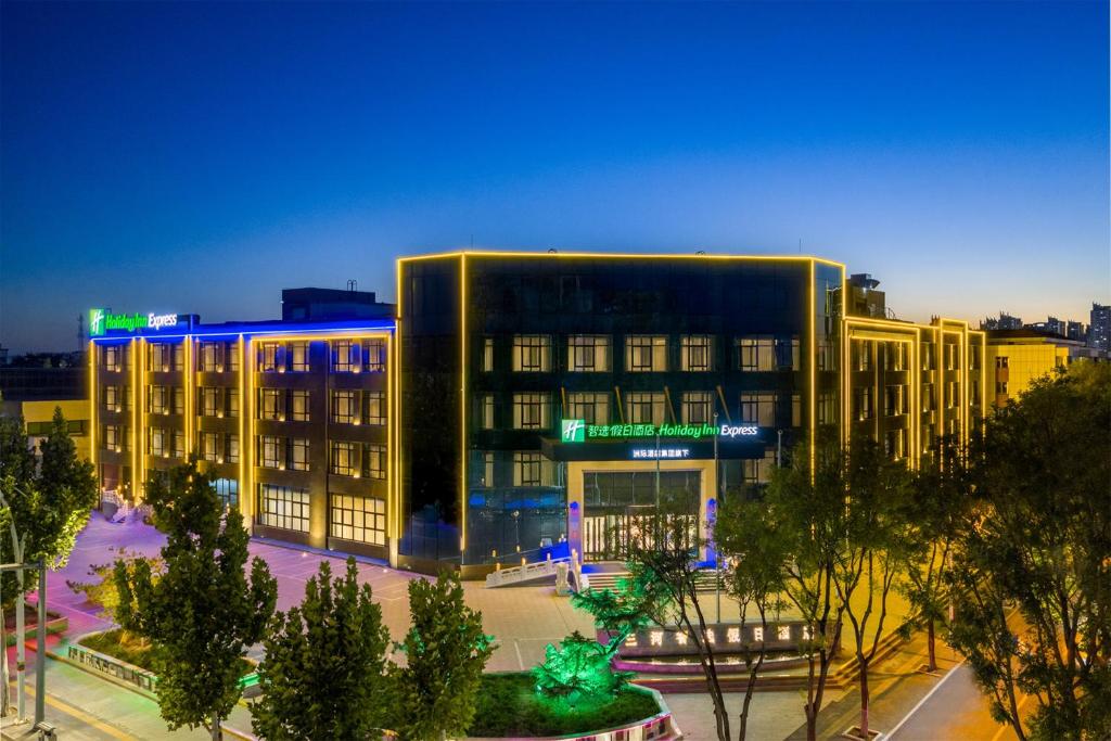 een groot gebouw in een stad 's nachts bij Holiday Inn Express Langfang Sanhe by IHG in Sanhe