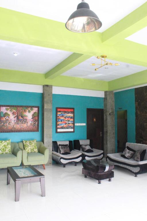 a living room with couches and tables and a ceiling at Wong Pai Ton Villa in Ngadisari