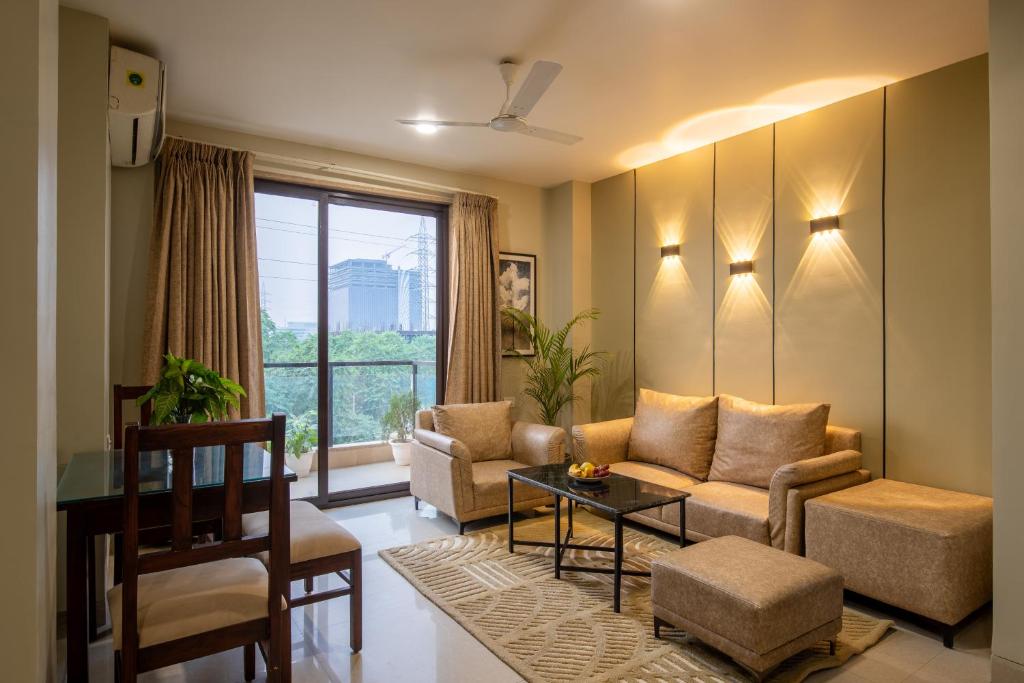 a living room with a couch and a table at BedChambers Serviced Apartment, Medicity in Gurgaon