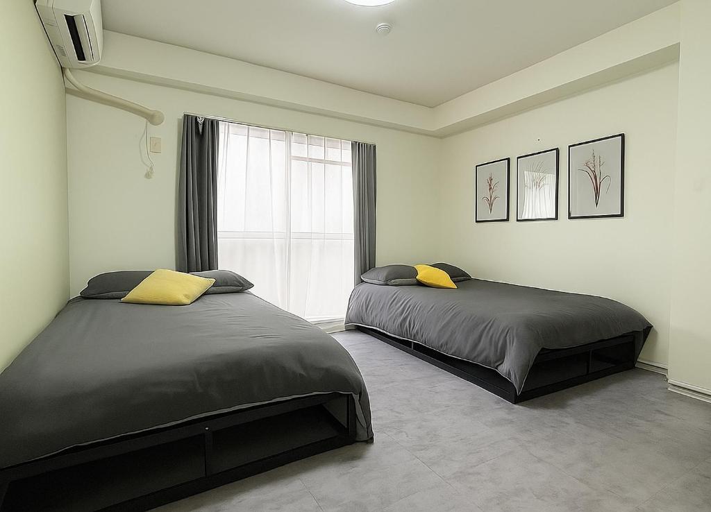 Ένα ή περισσότερα κρεβάτια σε δωμάτιο στο XeroB HOUSE FLOLIA602 フローリア