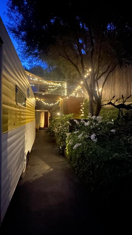 a white van parked in a yard with lights at Australian Retro Beach stay in Rye