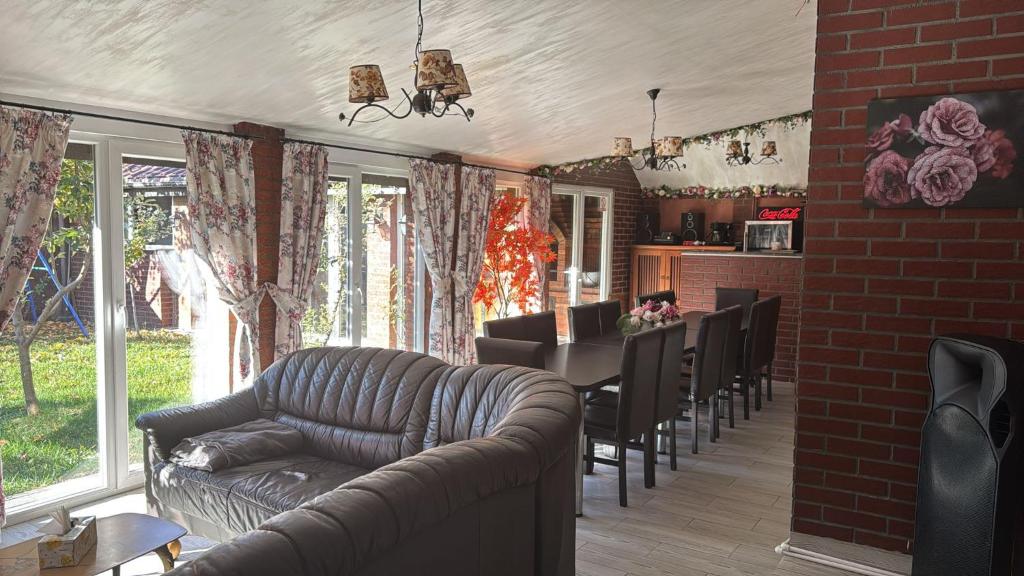 a living room with a couch and a table and chairs at Casa Rosa by MANAGR in Piatra Neamţ