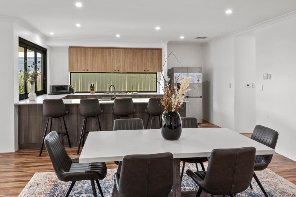 a kitchen and dining room with a table and chairs at Spacious Family Coastal Retreat, 4BR, BBQ in Dunsborough