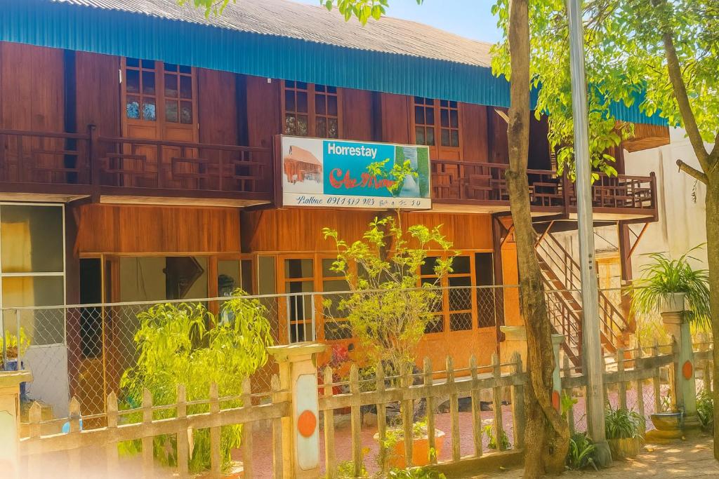 a building with a sign in front of it at Cầu Treo Homestay in Cham Ta Lao