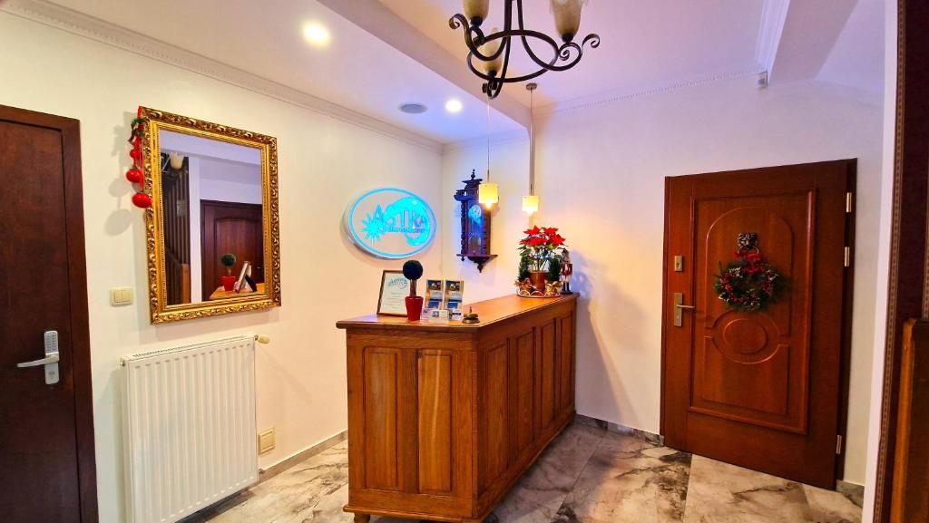 a hallway with a wooden door and a mirror at Astra Dziwnówek Dom Gościnny in Dziwnówek