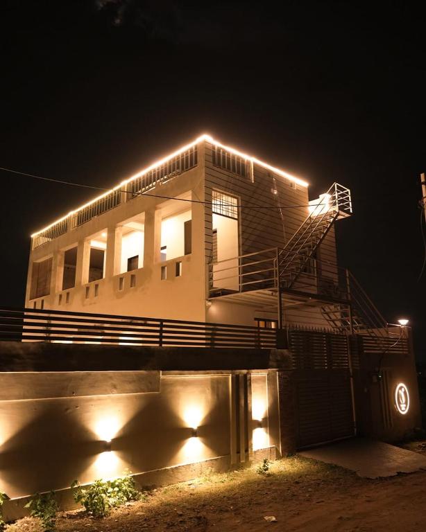 a house with lights on top of it at night at Narayani Villa in Udaipur