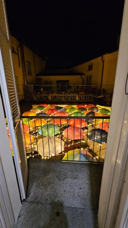 a bunch of colorful umbrellas sitting on a staircase at Mini Suite Trevigi in Casale Monferrato