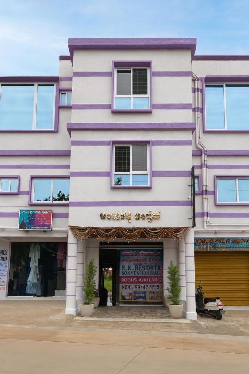 a pink and white building with a store at Rk Resorts in Bangalore
